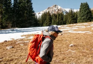 Girl in front of mountains considering pregnancy decisions such as abortion.